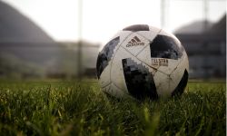 Football on grass pitch