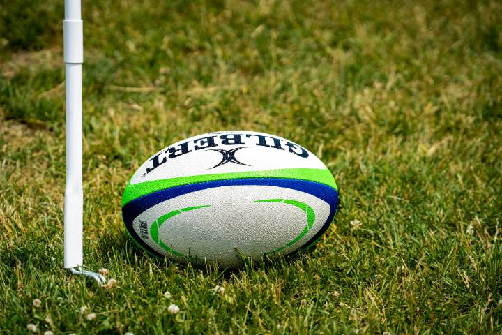 Rugby ball on a grassy pitch.