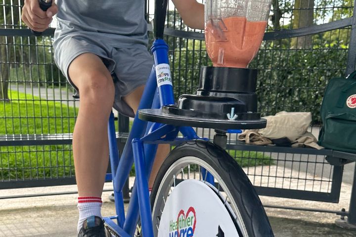 Person riding a bike that makes smoothies.