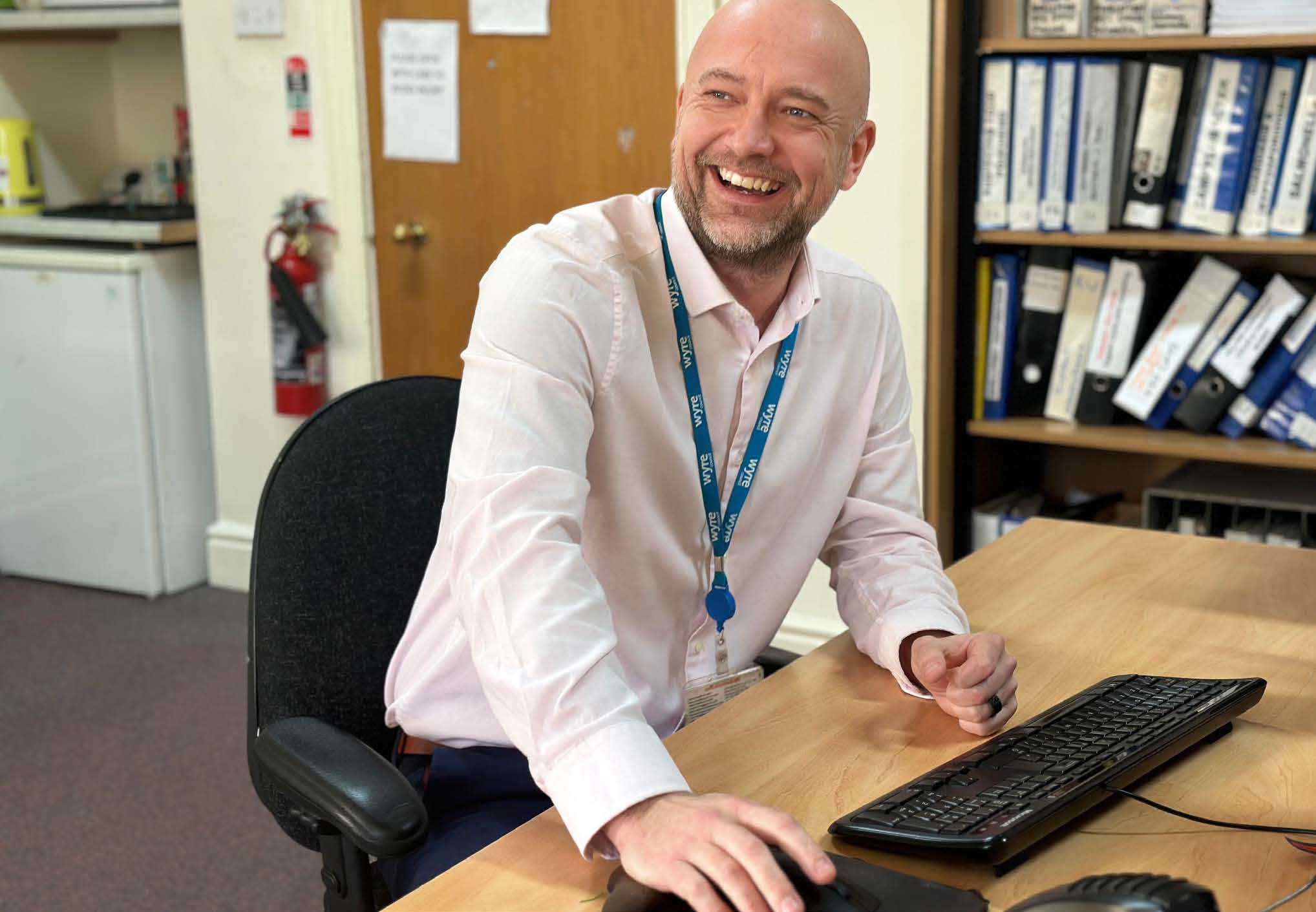 Smiling person using computer