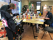 Creative crafts session - several people gathered around a table doing arts and crafts