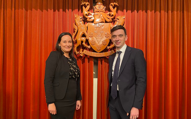 New Wyre Chief Executive and Leader stood together in front of red curtain in council chamber.