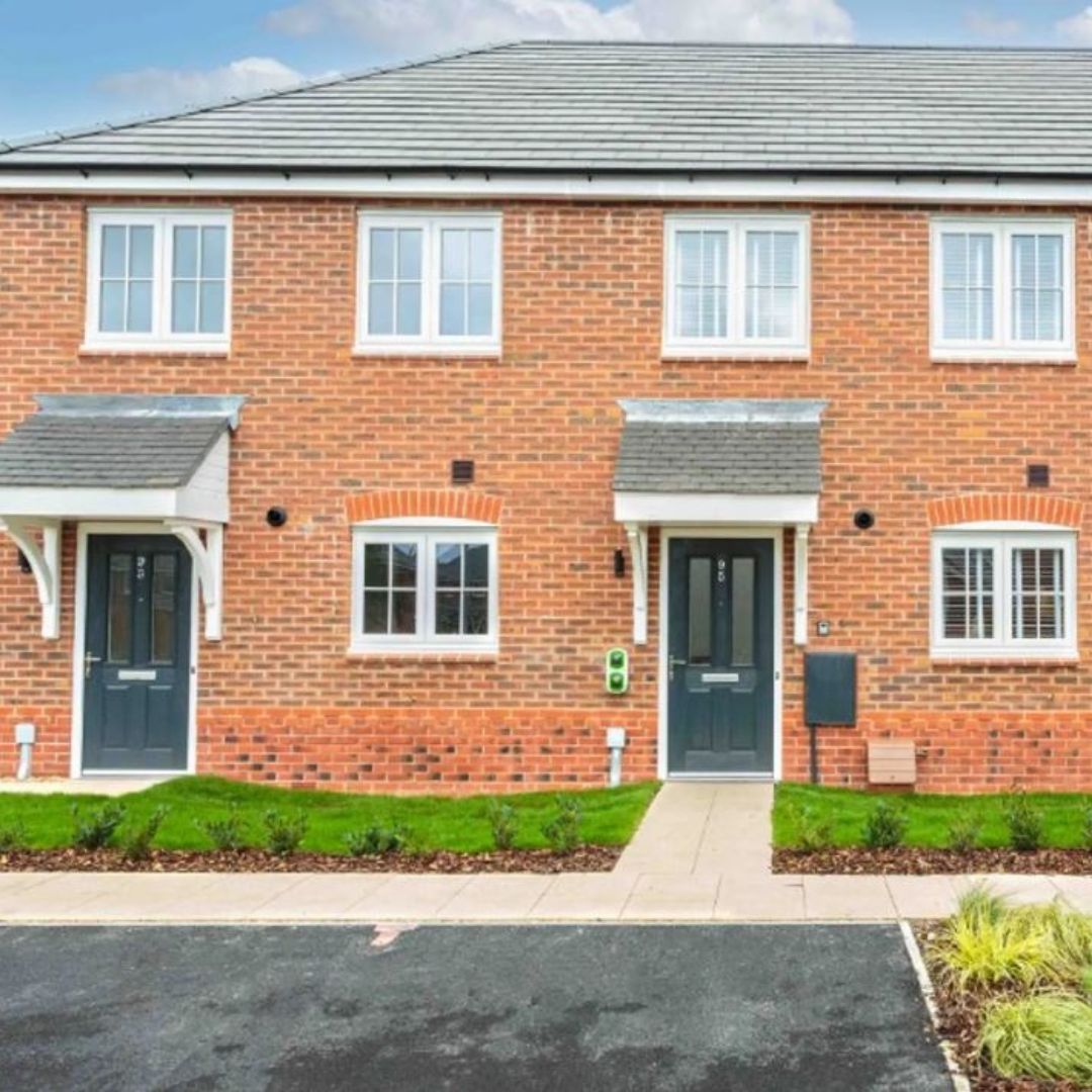 A row of modern orange brick terrace houses.