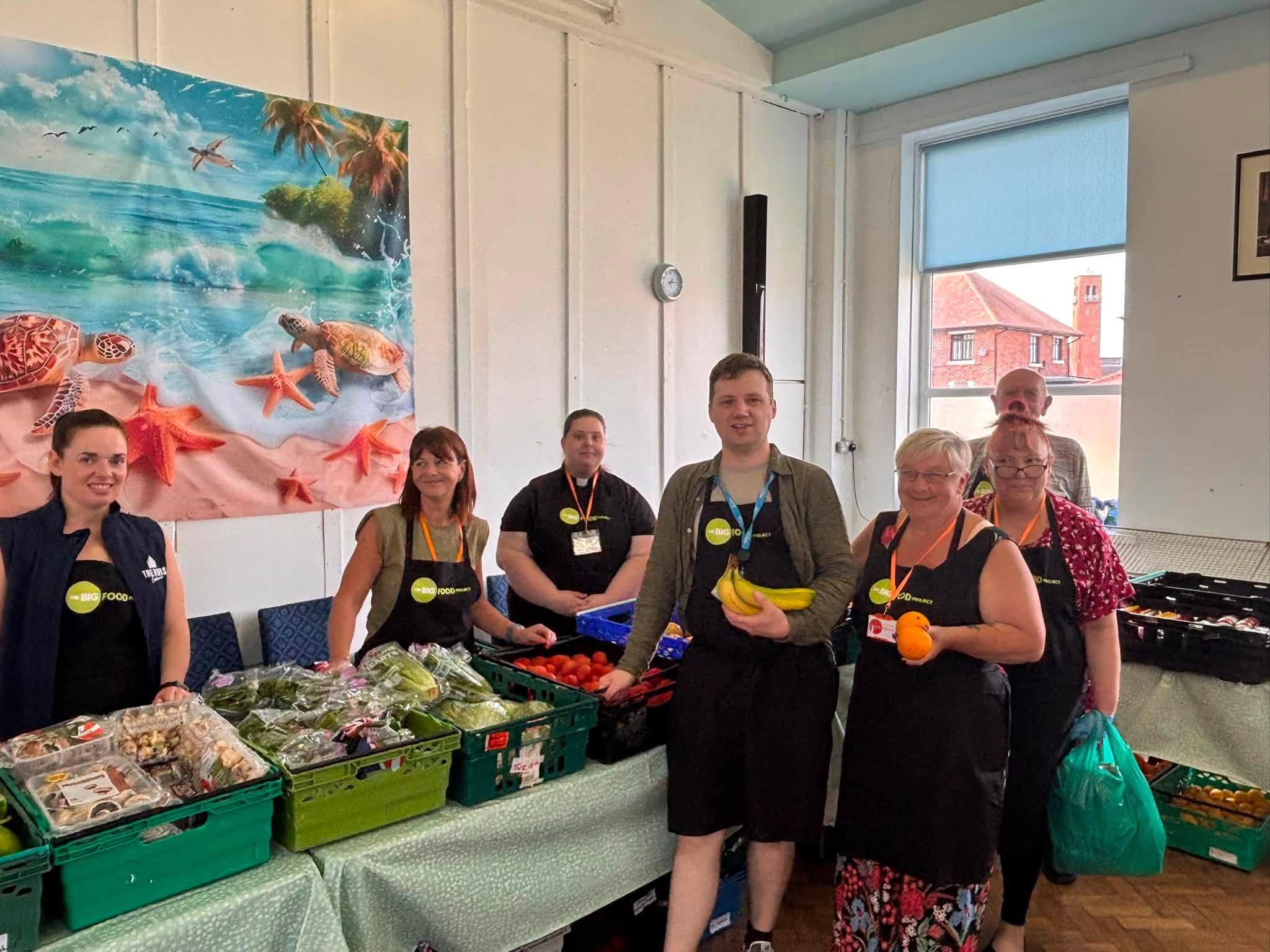 A group of workers and volunteers at a food bank