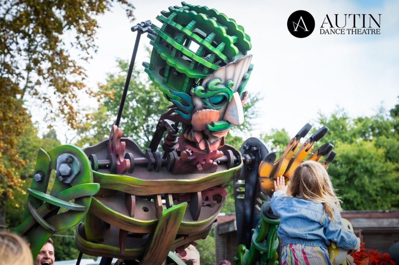 A giant mechanical puppet made out of cogs, nuts and bolts.