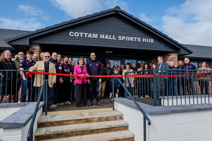 People stood outside the new Cottam Hall Sports Hub ready to cut the red ribbon to mark it's opening.
