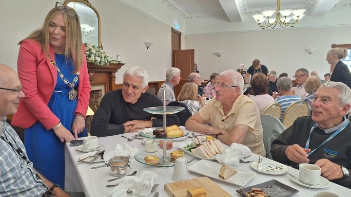 Deputy Mayor of Wyre Jane Preston talking to volunteers at an afternoon tea event.