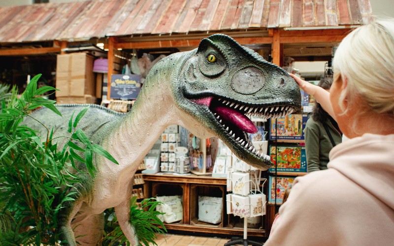 Realistic animatronic dinosaur in front of guests at Fleetwood Market.