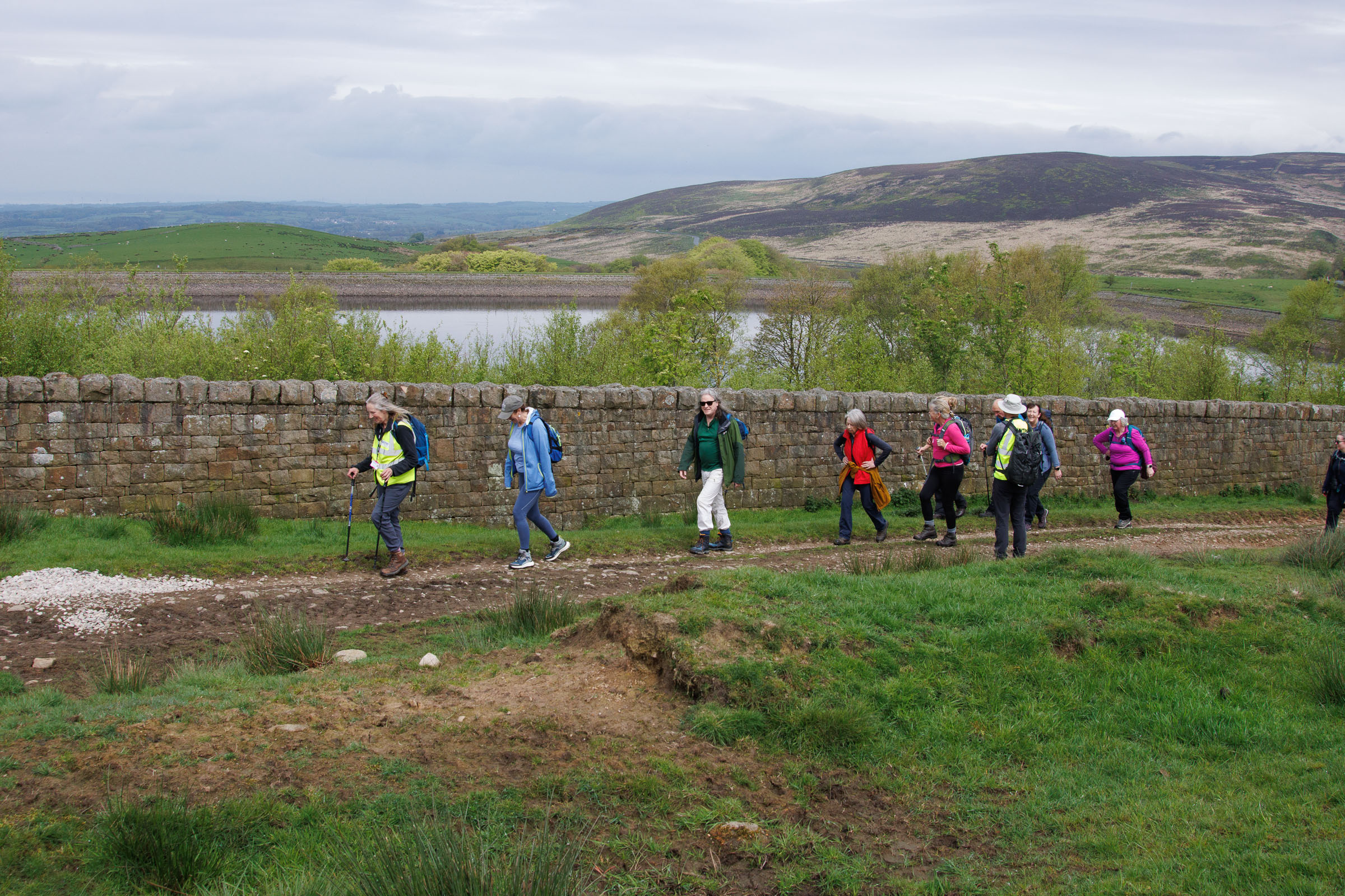 Line of people walking up a hill