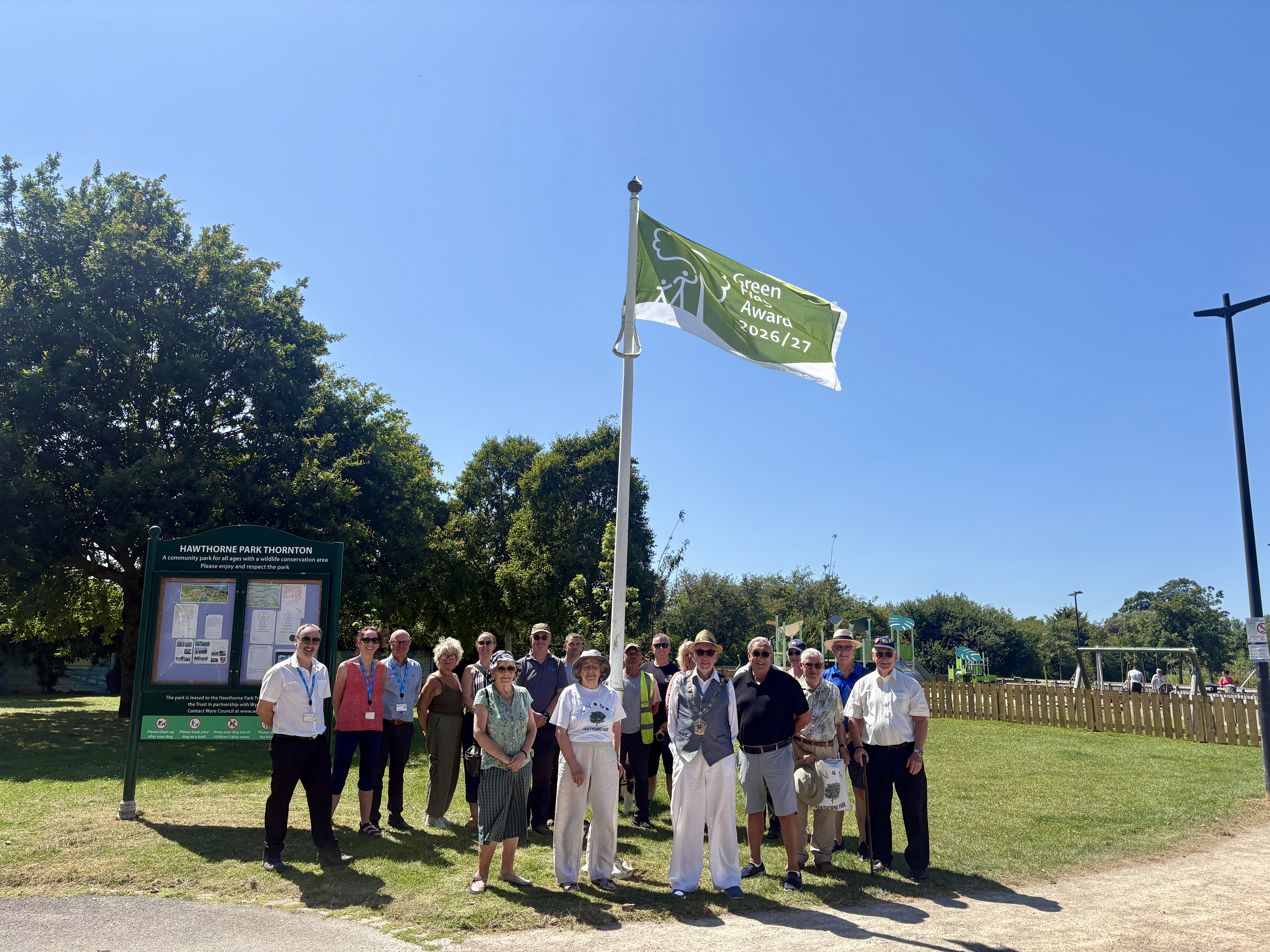 People holding the green flag award