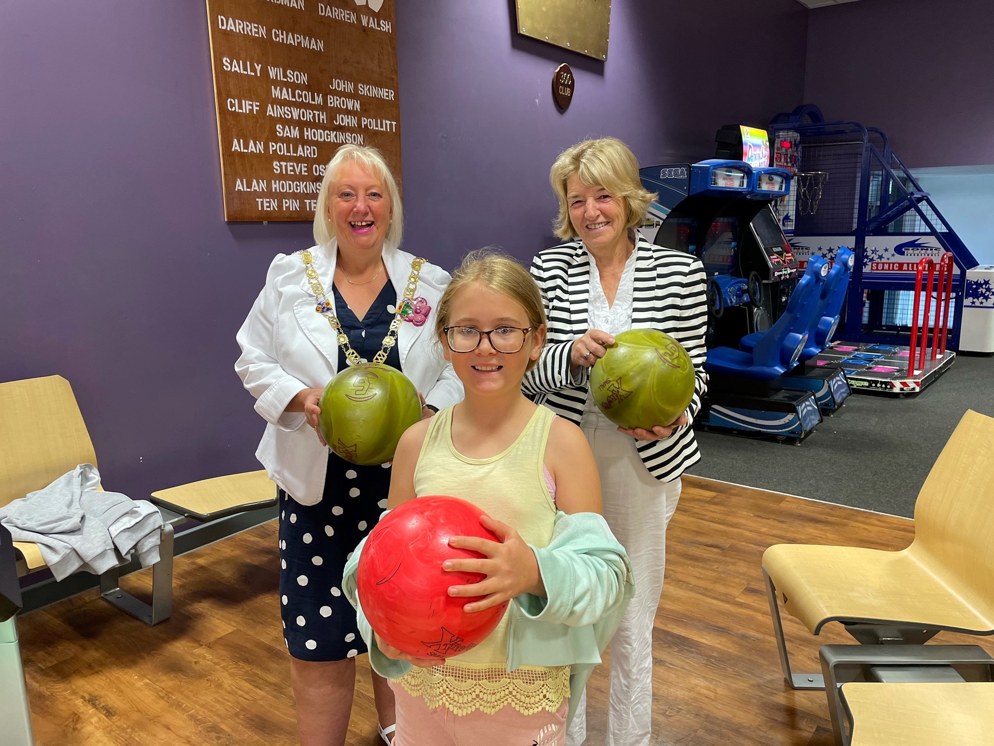 Councillor Kay and Councillor Bowen with a child from the holiday club