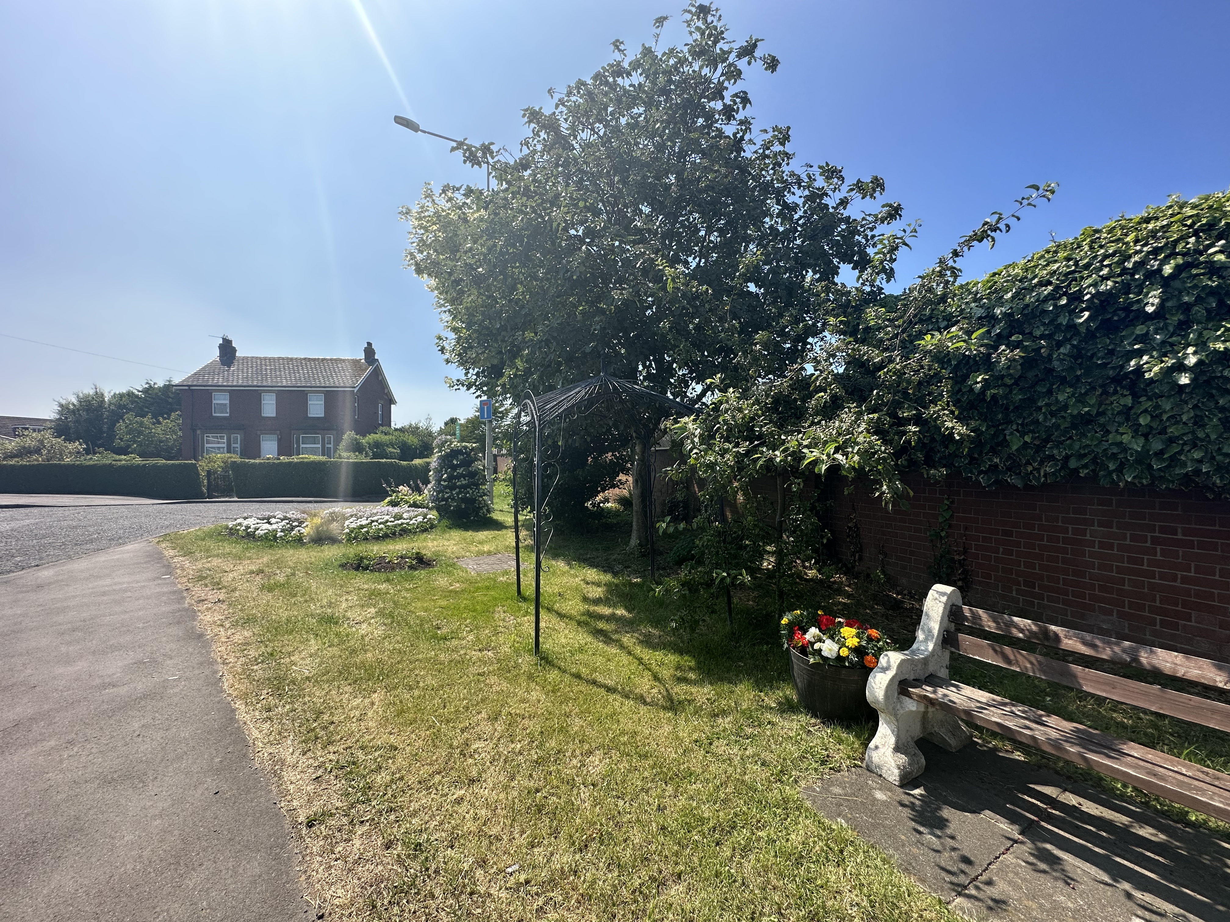 Hambleton village bench trees flowers