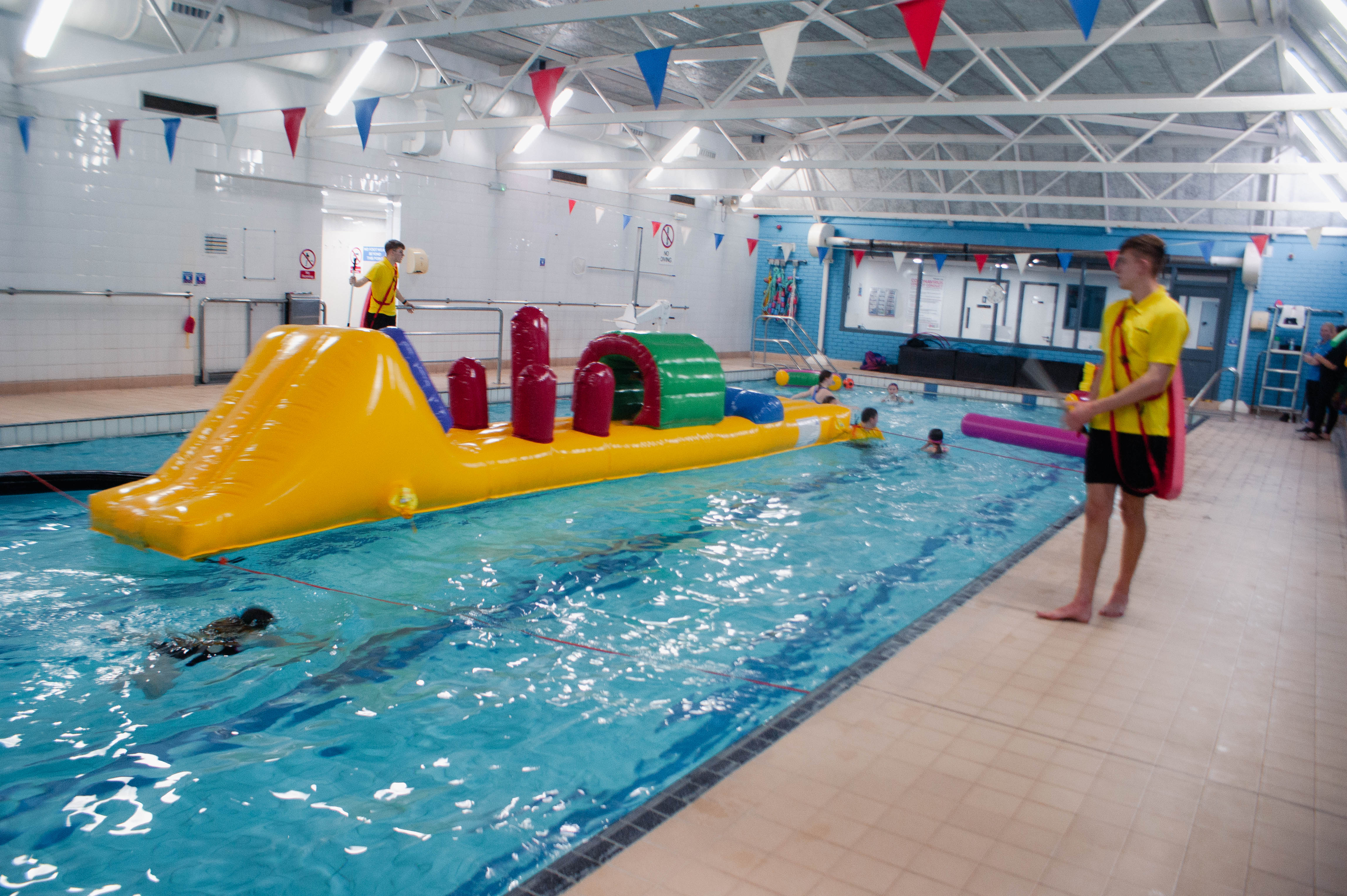 Indoor swimming pool with inflatable assault course.
