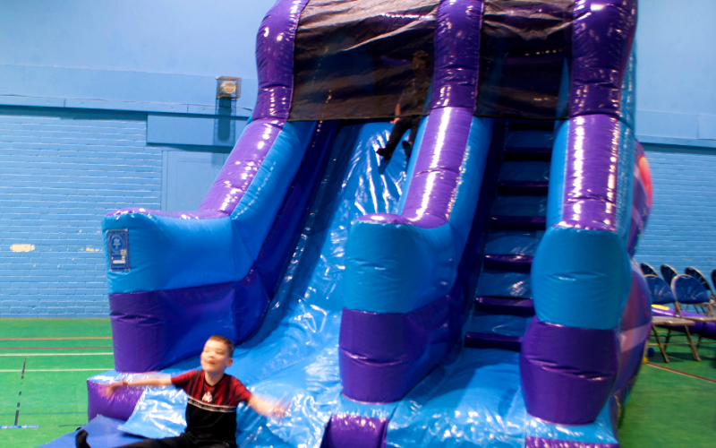 Child on inflatable slide.