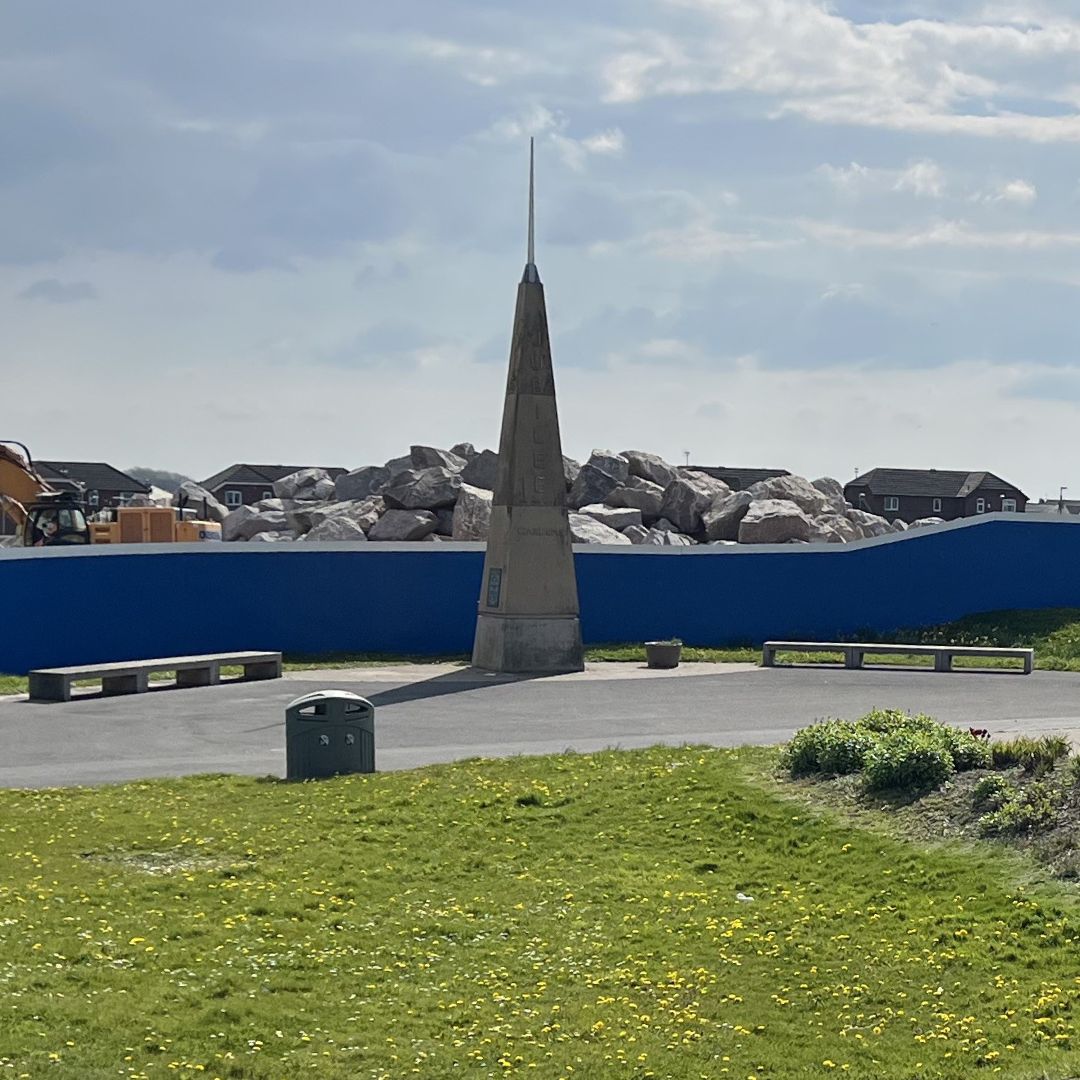 Jubilee Gardens, Cleveleys spire and benches surrounded by grass.
