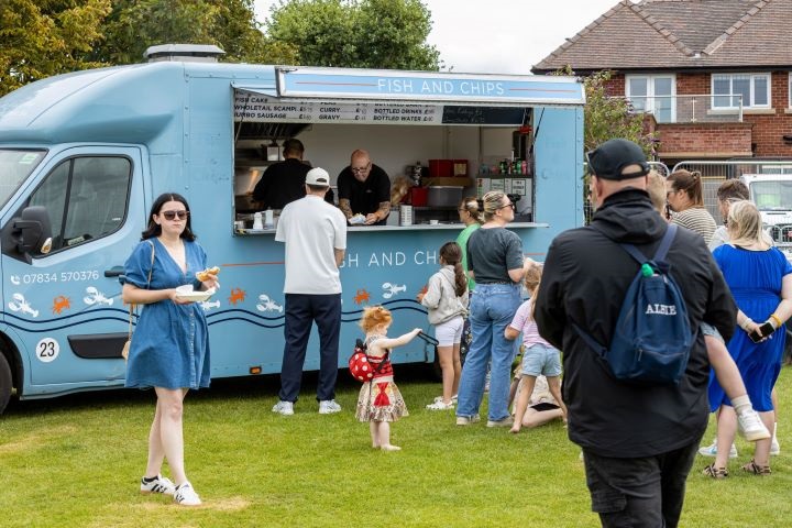 People queuing outside a Fish and Chips van