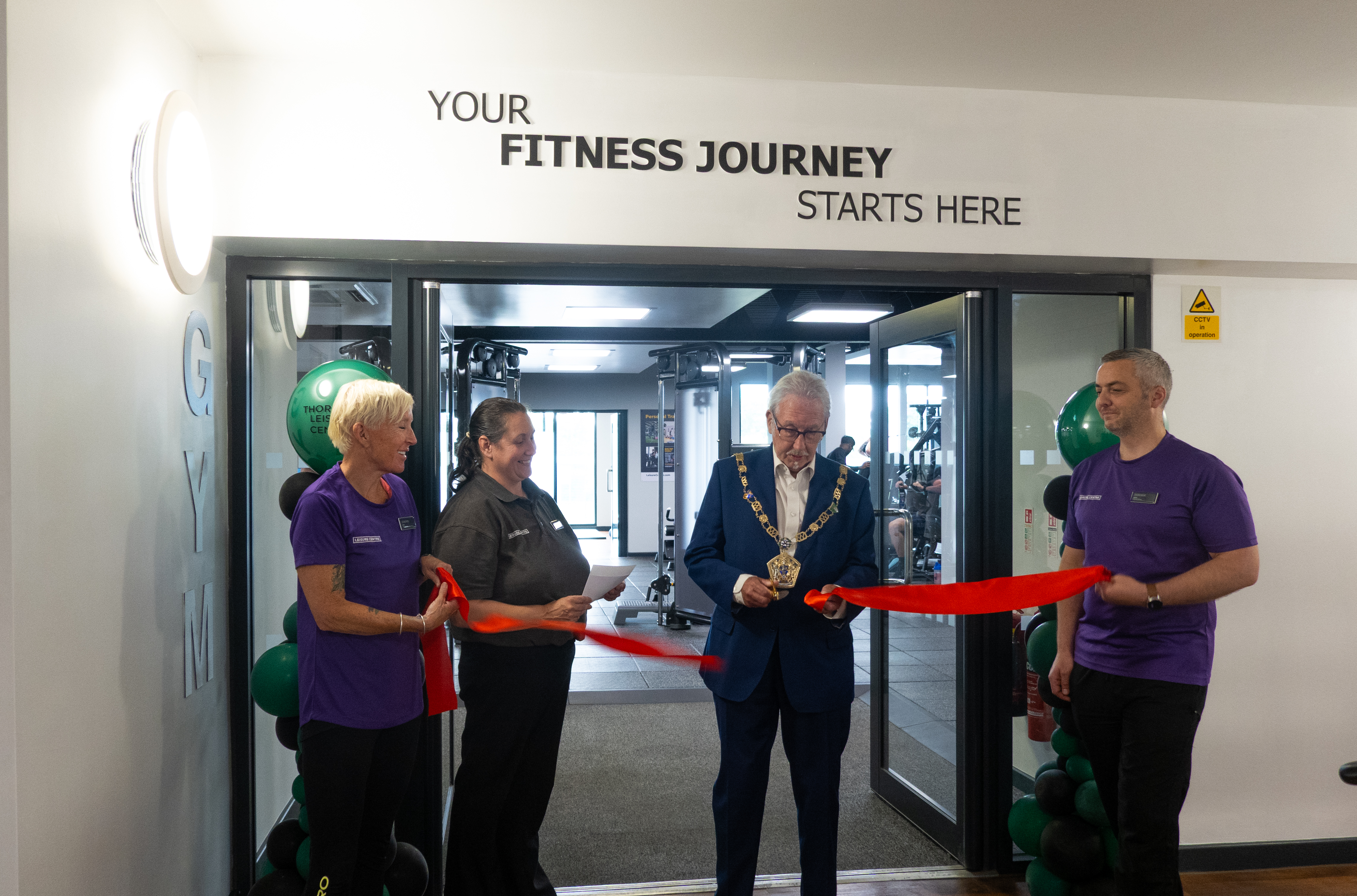 An image of the Mayor of Wyre cutting a red ribbon to open the new gym