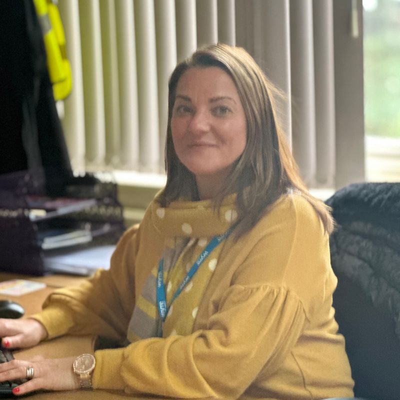 Sandra sat at her desk, smiling for camera in Wyre civic centre.