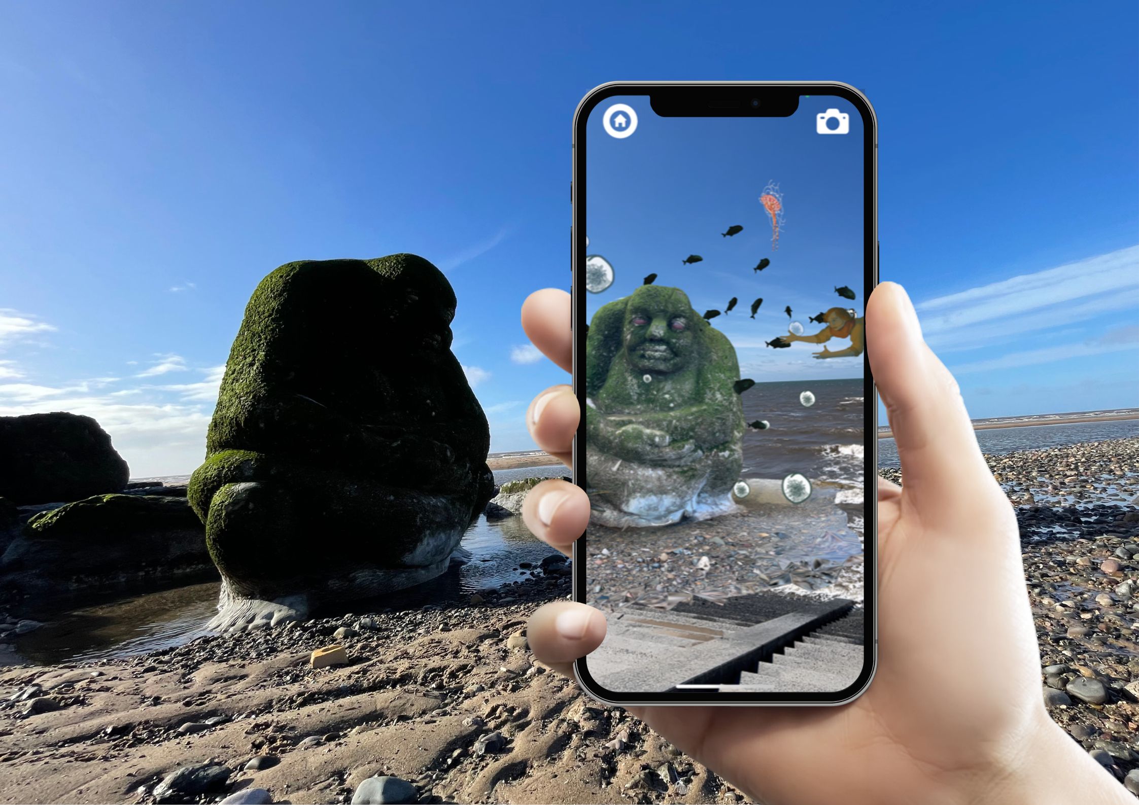 hand holding phone over ogre on beach