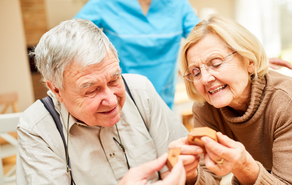 Two elderly people enjoying a craft activity