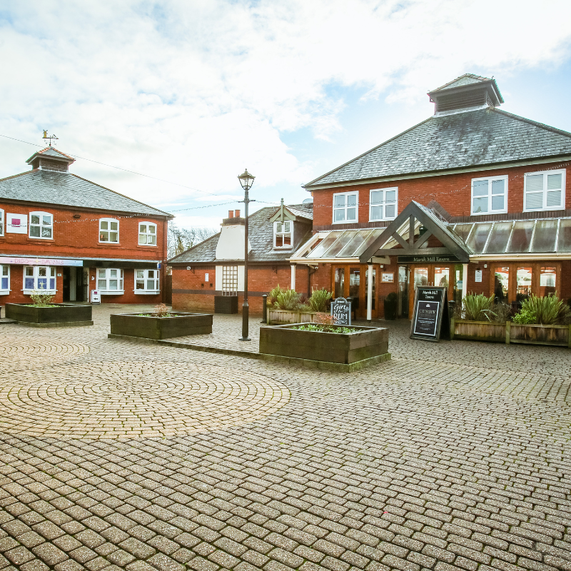 cobbled square and image of Tavern at the Mill