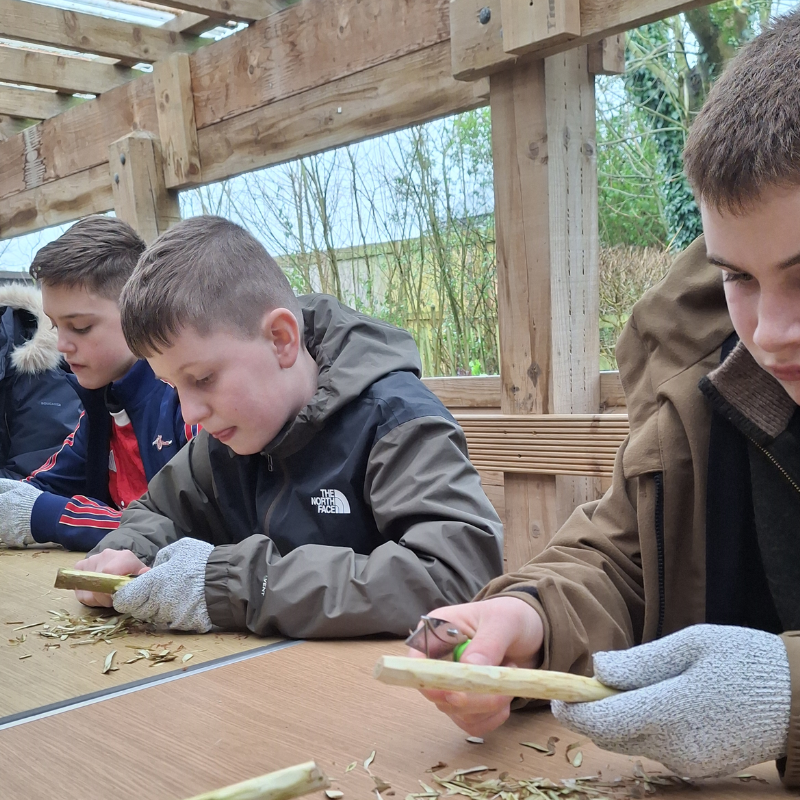 Group of people at a whittling session
