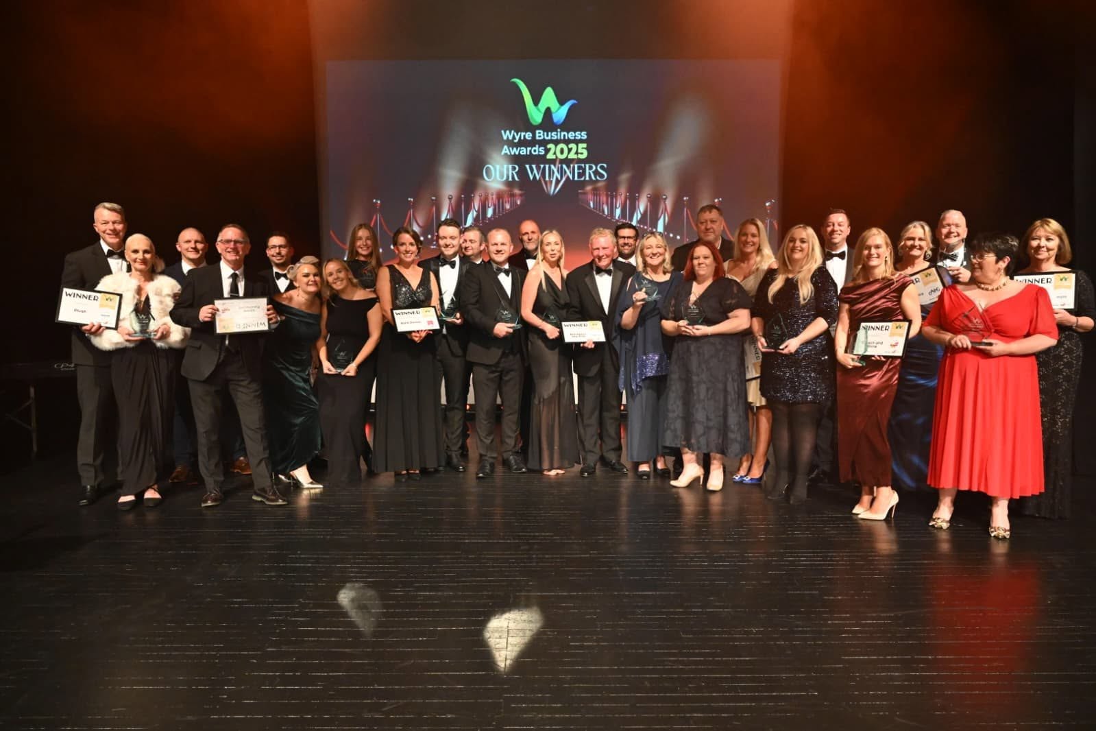 group of winners onstage with their awards