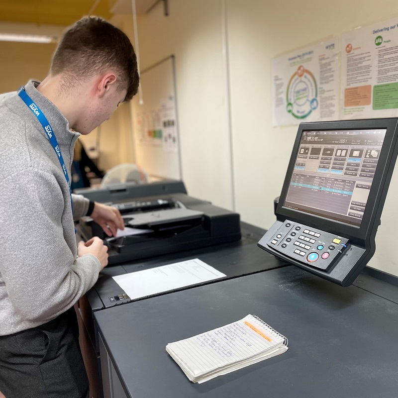 Apprentice using photocopying machine.