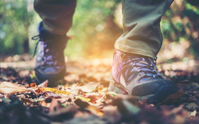 Close up of someones boots walking along a path