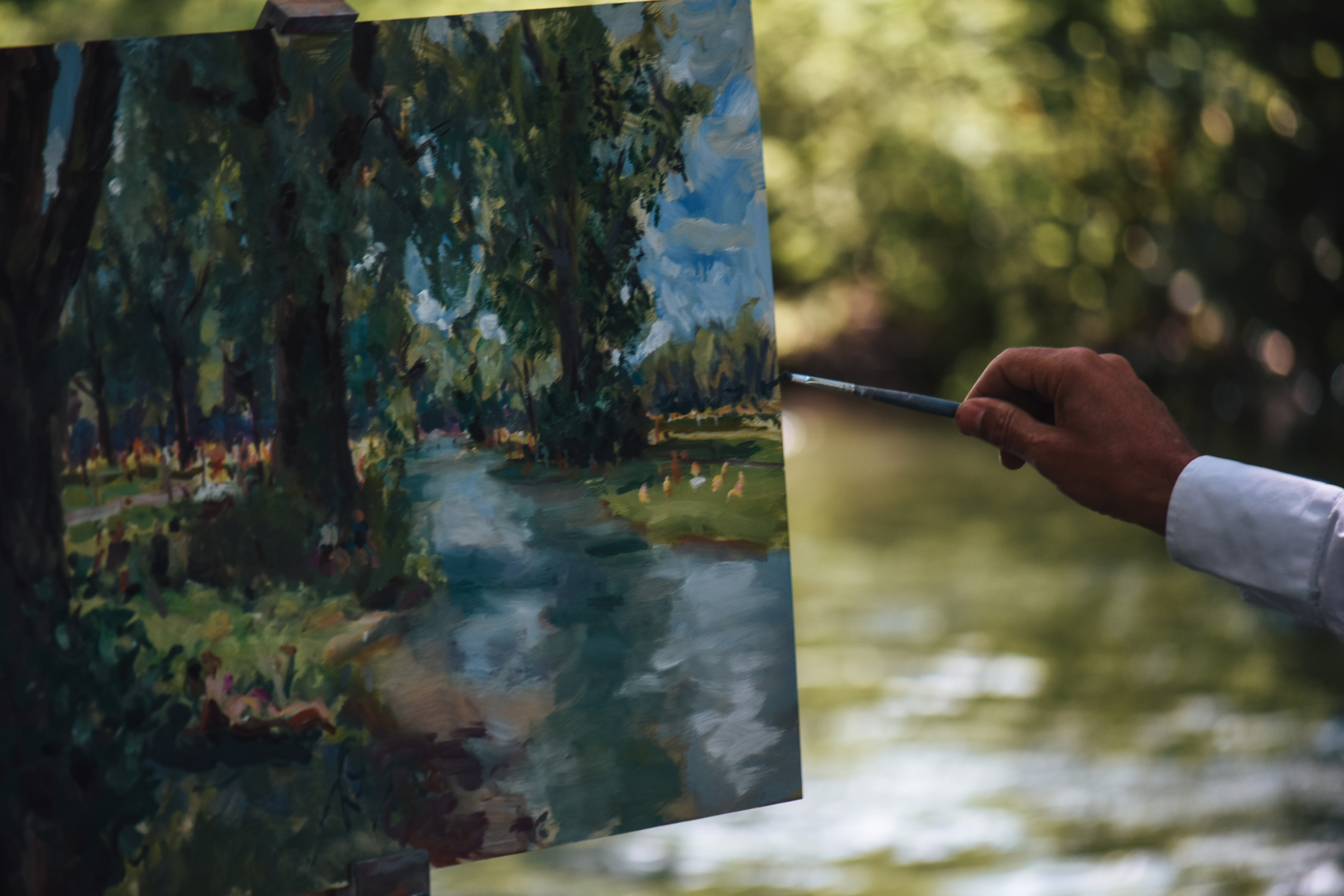 Hand painting by a river