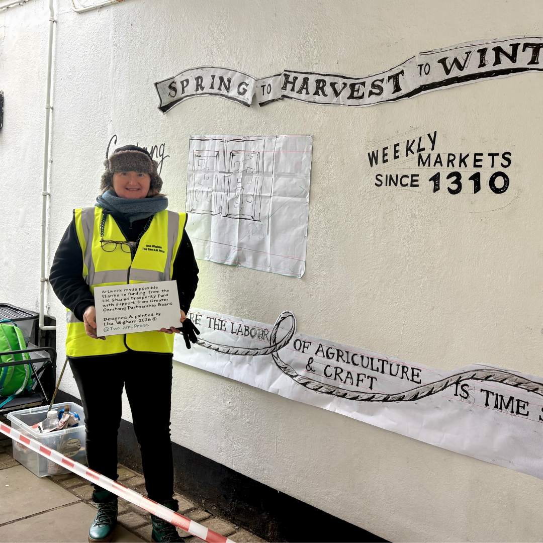 Artist Lisa Wigham in front of a wall