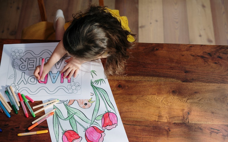 Young girl colouring in Easter themed pictures.