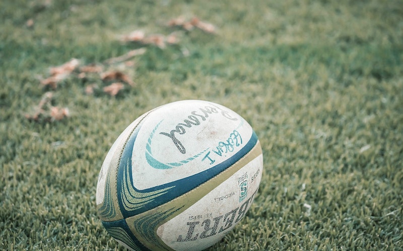 Rugby ball laying on grass.