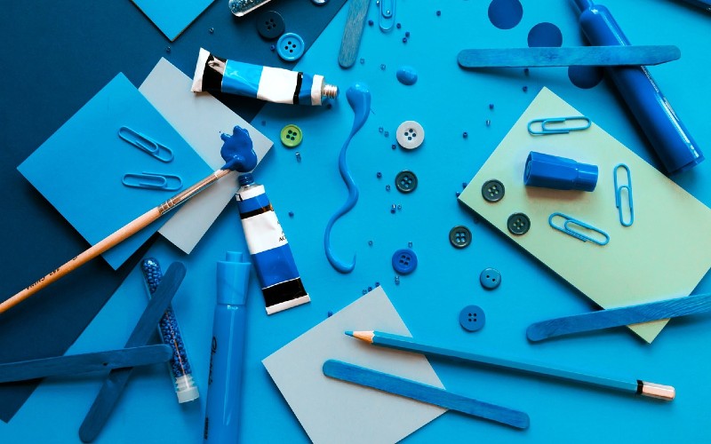 Lots of blue craft materials arranged on a table.
