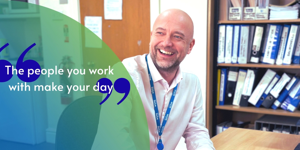 Radford, Environmental Health Technical Officer at Wyre council is sat at his desk smiling with a quote "The people you work with make your day."