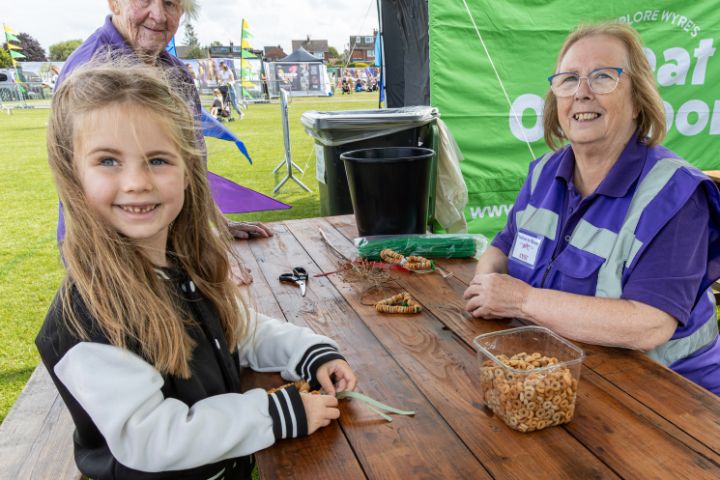A child making bird feeders out of cereal.